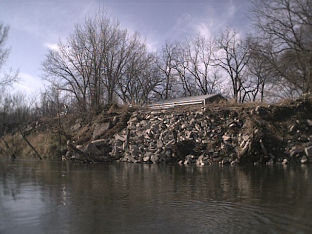 Loads of broken concrete and dirt pushed into river at 4380 Grand